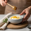 Honey Drizzling Over Creamy Yogurt in Rustic Kitchen Setting