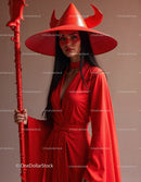 Elegant Woman in Red Dress with Accessories Against Red Background