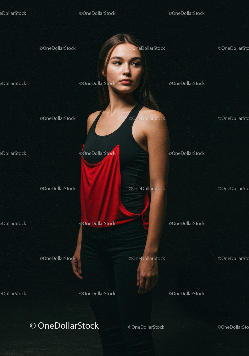 Thoughtful young woman standing against dark background