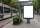 Modern tram stop with blank advertising board in city