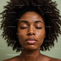 Young woman with curly hair enjoying facial mask skincare treatment