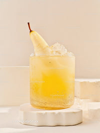 Chilled Pear Cocktail with Ice on White Pedestal