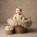 Adorable Baby Girl Sitting in Cozy Basket with Soft Blanket