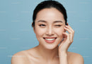 Portrait of a Smiling Winking Woman with Flawless Skin on Blue Background