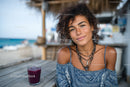 Young Woman Smiling at Beachside Cafe in Summer Setting