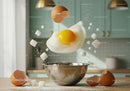 Fresh egg and sugar falling into metal mixing bowl