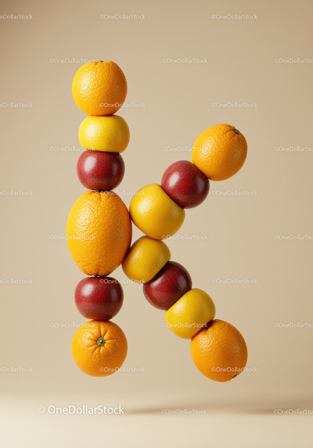 Letter K formed with fresh citrus and apples