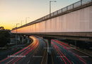 City Highway with Light Trails During Sunset in Urban Environment