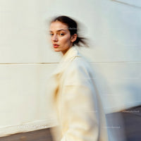 Stylish Woman in Motion Wearing Elegant Beige Outfit