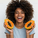 Joyful Woman Holding Fresh Papayas Smiling Brightly