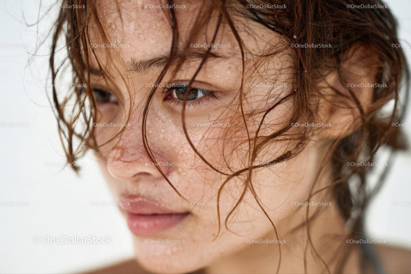 Close-Up of Young Woman with Wet Hair and Freckles