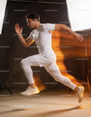 Athlete sprinting powerfully in studio with motion blur