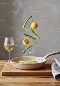 Fresh asparagus and lemon cooking with white wine
