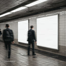 Blurred commuters passing blank advertising panels underground