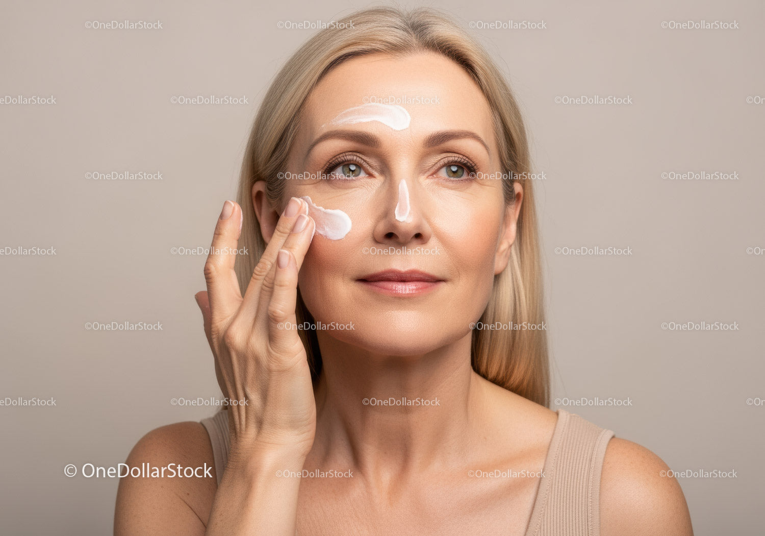 Beautiful Mature Woman Applying Skincare with Moisturizer