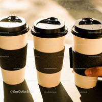 Three Disposable Coffee Cups with Black Sleeves on Table
