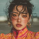 Close-Up of a Woman with Dark Hair and Golden Jewelry in Glamorous Style
