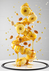 Banana Slices and Peanuts Drizzled with Honey in Motion