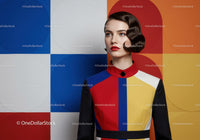 Woman in Bold Colorblock Dress Against Geometric Wall