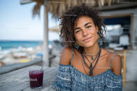 Young Woman Smiling at Beachside Cafe with Tropical Vibe