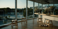 Modern Indoor Lounge with Floor-to-Ceiling Windows and Scenic City View