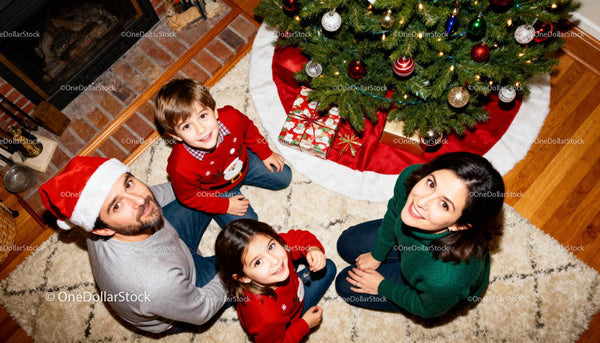 Family Enjoying Cozy Christmas Moments by Tree