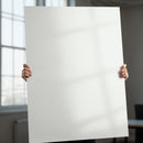 Person Holding Blank White Poster in Modern Office