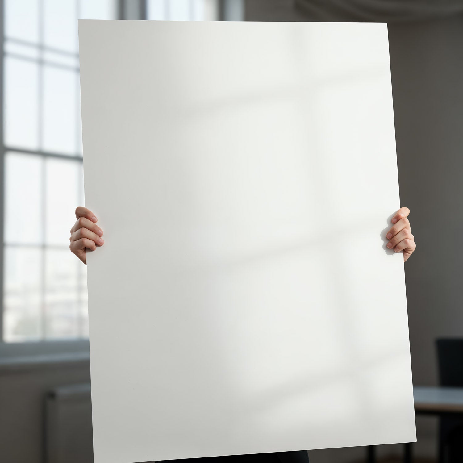 Person Holding Blank White Poster in Modern Office