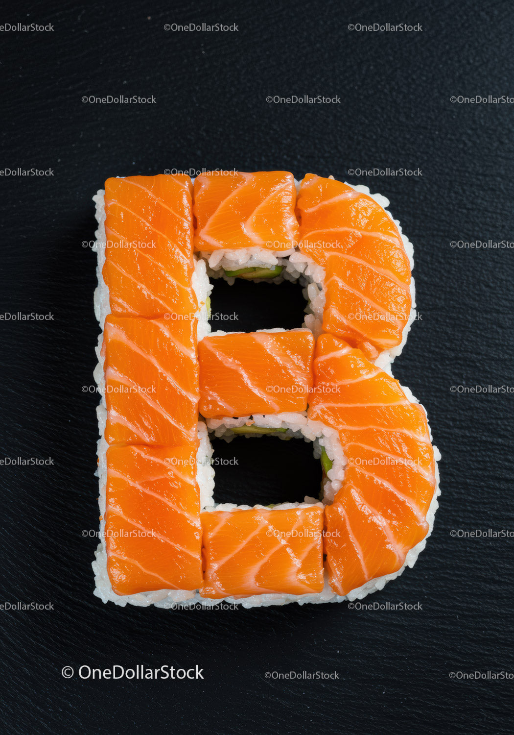 Salmon Sushi Arranged in Letter B on Black Plate