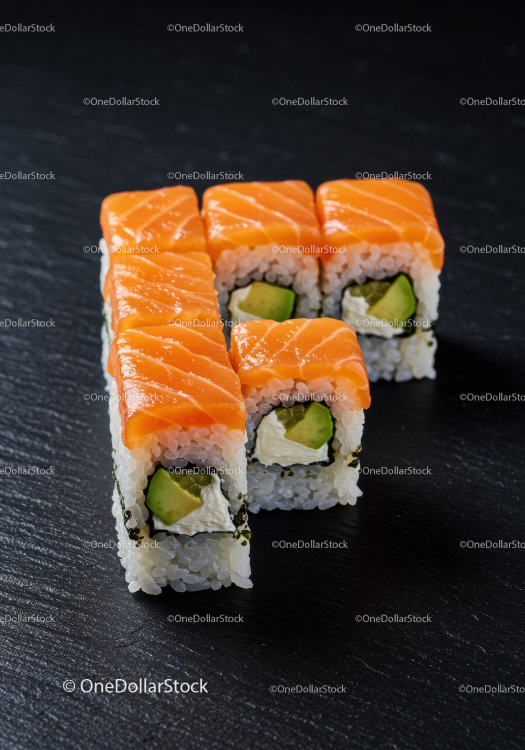 Świeże rolki sushi z łososiem i awokado na czarnym łupku