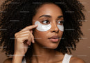 Beautiful woman with eye patches applying skincare facial mask