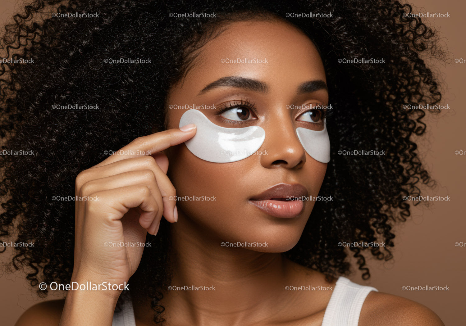 Beautiful woman with eye patches applying skincare facial mask