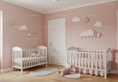 Cute Baby Nursery with Pink Walls and Cloud Wall Decor