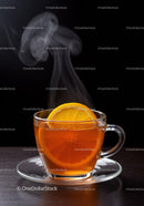Steaming cup of black tea with fresh orange slice