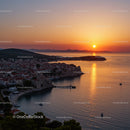 Beautiful Sunset Over Coastal Village With Red Roofs And Calm Sea