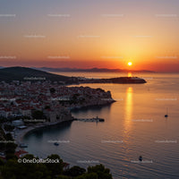 Beautiful Sunset Over Coastal Village With Red Roofs And Calm Sea