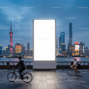 Urban Nightscape with Cyclists and Illuminated Billboard