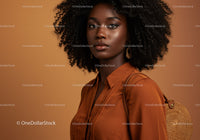 Elegant Woman with Curly Hair in Stylish Outfit in Warm Studio Setting