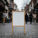 Blank wooden signboard on cobblestone city street