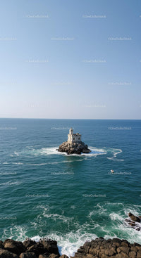 Small Lighthouse on Rocky Island Over Calm Blue Ocean