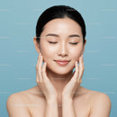 Close-Up of a Woman with Clear Glowing Skin on Light Blue Background