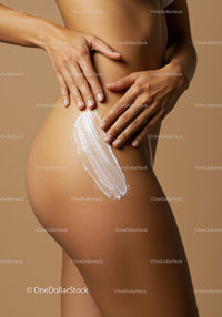 Close-up of a Nude Woman Applying Body Lotion to Smooth Skin