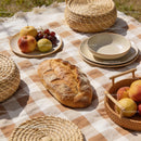 Rustic picnic setup with fresh fruits and crusty bread