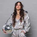 Stylish Woman in Metallic Outfit Holding Disco Ball for Modern Fashion