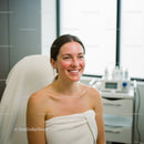 Young Woman Smiling During Facial Treatment in Spa
