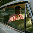 Young Man Sitting in Vintage Car with Open Window Outdoor Scene