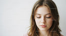 Beauty Portrait of a Young Woman with Brown Hair and Soft Makeup