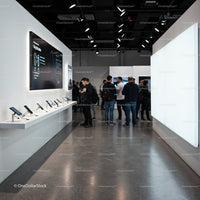 Group of people exploring latest smartphones at tech event