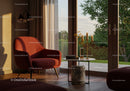 Cozy living room corner with red armchair and natural light