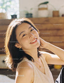 Young woman smiling warmly in bright natural light
